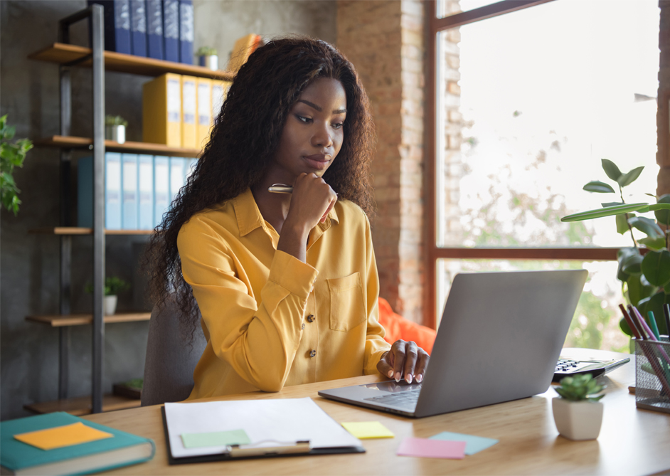 Image of a lady sat working at her computer.