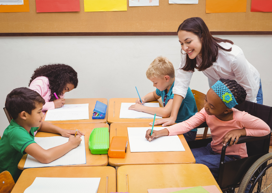 Image of school children sat at their table learning.